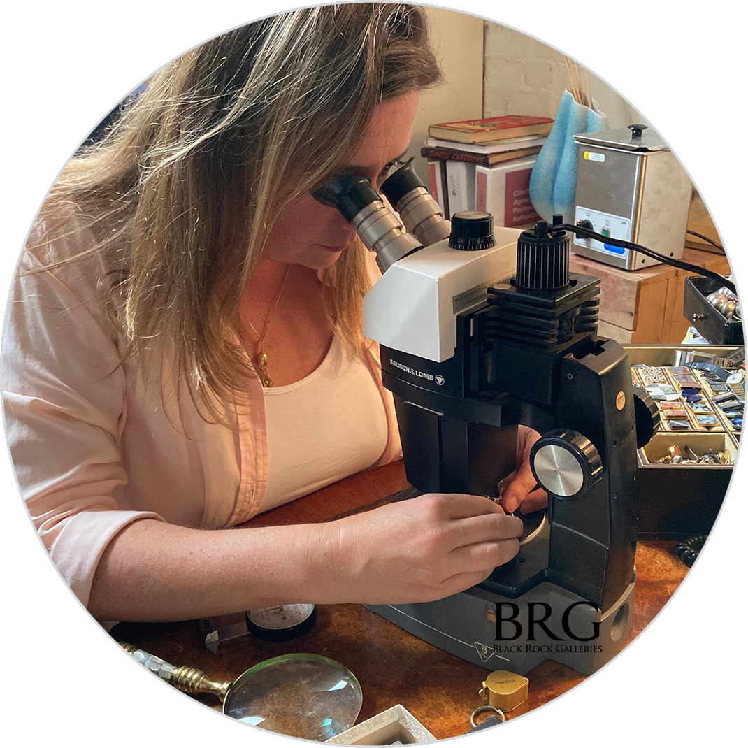 Precious and semi-precious stones are inspected under a jeweler's microscope